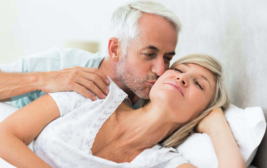 Mature happy couple embracing each other in bed after using horny goat weed blend